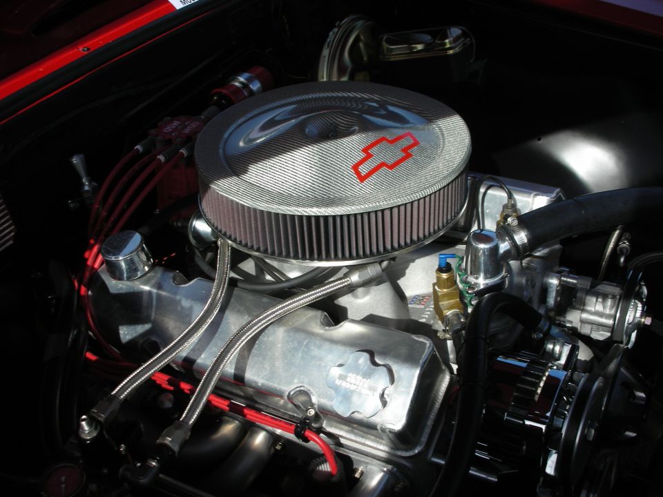 Chrome round air cleaner with red Chevrolet bowtie atop a polished V8 engine