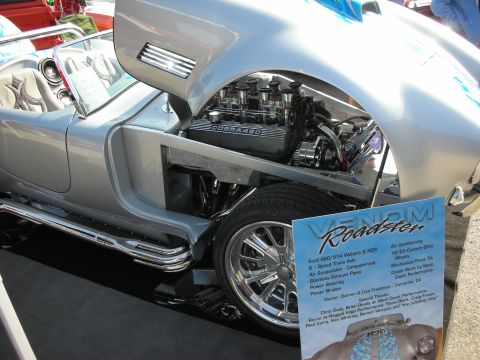 1998 Ford Crown Victoria - A custom Venom Roadster is displayed with its hood open, revealing a powerful engine and intricate chrome details.