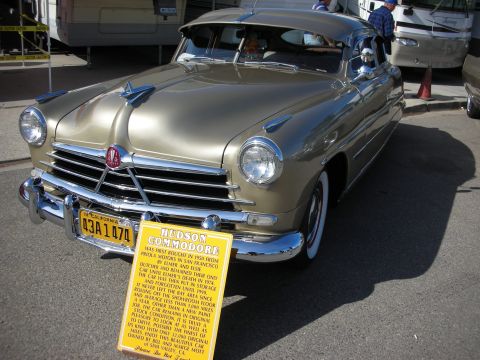 1998 Ford Crown Victoria - A 1950 Hudson Commodore is displayed with a descriptive sign detailing its history.