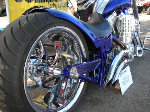 1998 Ford Crown Victoria - A blue custom motorcycle is shown from the rear, with a 'FOR SALE' sign visible.