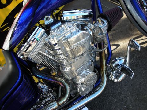 1998 Ford Crown Victoria - Close-up of a highly polished chrome motorcycle engine, a PR 120 designation and a vibrant blue frame.