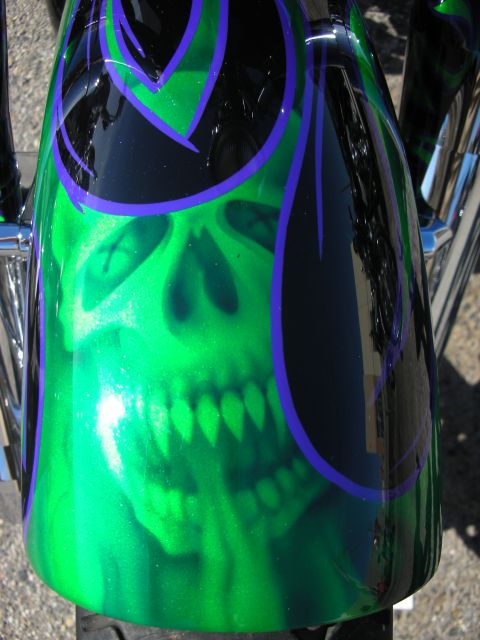 1998 Ford Crown Victoria - Motorcycle fender features a custom airbrushed design of a skull with green flames and purple accents.
