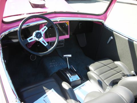 1998 Ford Crown Victoria - Interior view of a custom pink hot rod, bucket seats and a modern steering wheel.