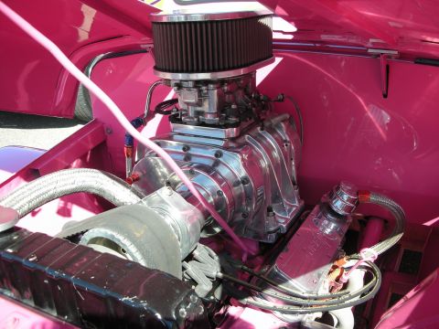 1998 Ford Crown Victoria - The engine bay features a prominent supercharger and custom pink paintwork.