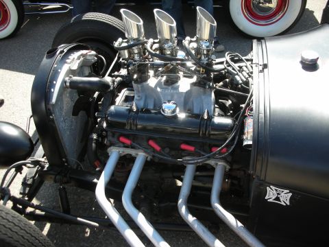 1998 Ford Crown Victoria - Close-up of a custom hot rod engine a V8 configuration and prominent exhaust headers.