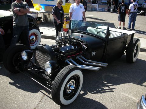 1998 Ford Crown Victoria - A custom hot rod is displayed outdoors with people standing around it.