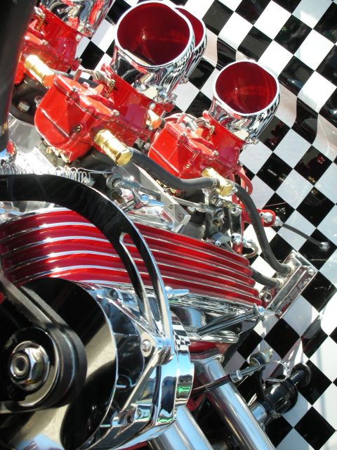 1998 Ford Crown Victoria - Close-up of a custom engine with dual carburetors and a checkerboard pattern in the background.