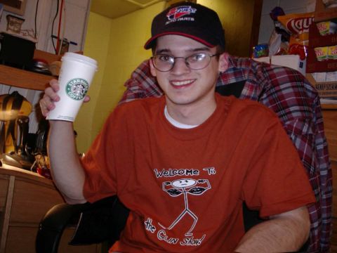 1989 Ford Bronco - A man wearing glasses and a cap smiles while holding a Starbucks coffee cup.