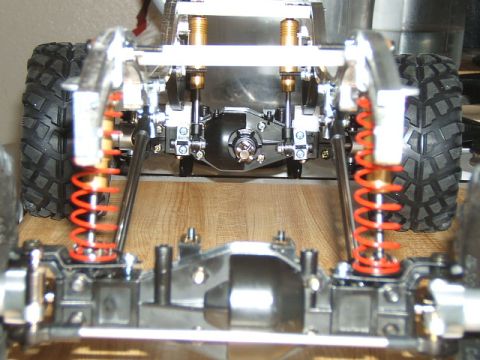 1988 Ford Bronco - The intricate suspension system of a remote-controlled crawler is shown from the rear.