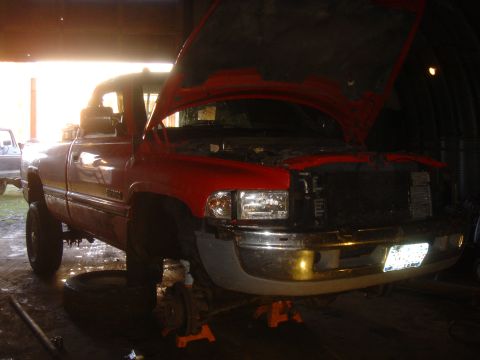 1979 Ford F-250 - This red pickup truck is undergoing repairs in a dimly lit garage.