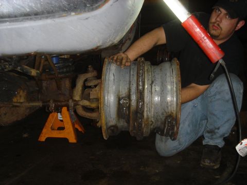 1979 Ford F-250 - Working on the suspension of a truck, removing a wheel hub assembly.