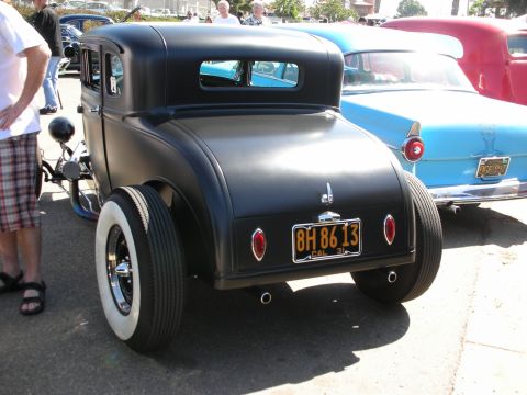 1998 Ford Crown Victoria - Rear view of a black hot rod coupe with whitewall tires and a California license plate.