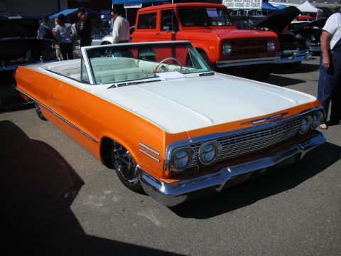 1998 Ford Crown Victoria - Two-tone convertible parked at an outdoor event with other vehicles present.