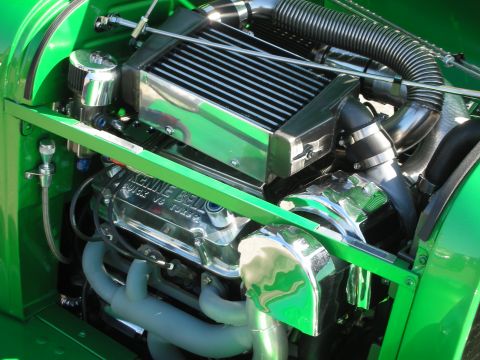 1998 Ford Crown Victoria - Close-up of a custom engine bay with a supercharger and polished components.