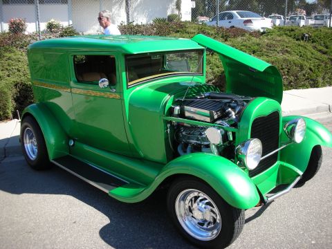 1998 Ford Crown Victoria - Customized green sedan delivery hot rod parked outdoors with hood open.
