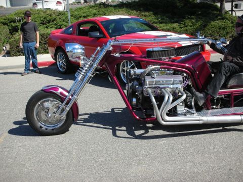 1998 Ford Crown Victoria - Custom trike motorcycle with V8 engine parked in front of a red Ford Mustang.