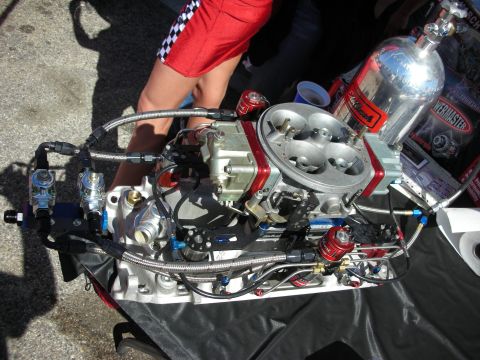 1998 Ford Crown Victoria - Engine components are laid out on a table, with a person in checkered shorts standing nearby.