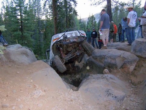 1995 Ford Bronco - This 1995 Ford Bronco is stuck on a rocky trail, with onlookers observing the difficult situation.