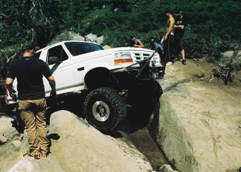 1995 Ford Bronco - This 1995 Ford Bronco is tackling a difficult rocky obstacle on an off-road trail.