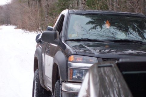 2000 Chevrolet Tahoe - A black pickup truck is seen from the front quarter angle on a snowy road.