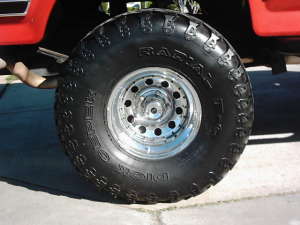 1986 Ford Bronco - Close-up of a 1986 Ford Bronco's front wheel and tire assembly.
