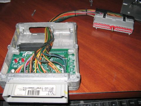 1991 Ford Bronco - This is a Ford engine control unit with its wiring harness attached, shown on a desk.