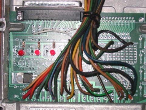 1991 Ford Bronco - An electronic control unit's wiring harness is shown connected to the circuit board, with multiple colored wires leading into the component.