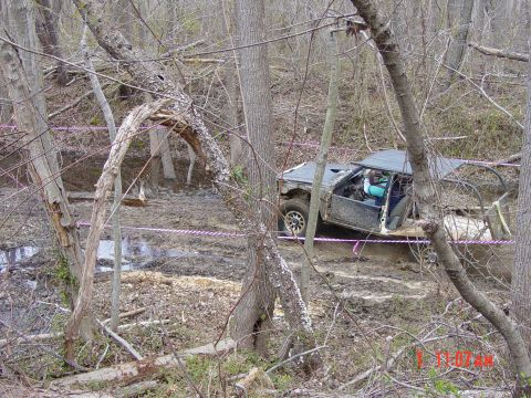 1995 Dodge 1500 - An off-road vehicle is stuck in the mud on a wooded trail.