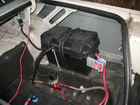 1985 Ford LTD Crown Victoria - The trunk interior displays a battery, fuel lines, and wiring, with a 'Supermotors' logo visible.