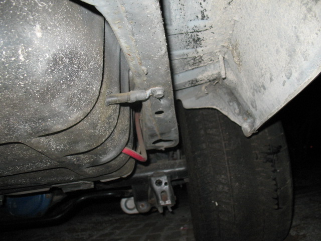 Underbody view of fuel tank and suspension components
