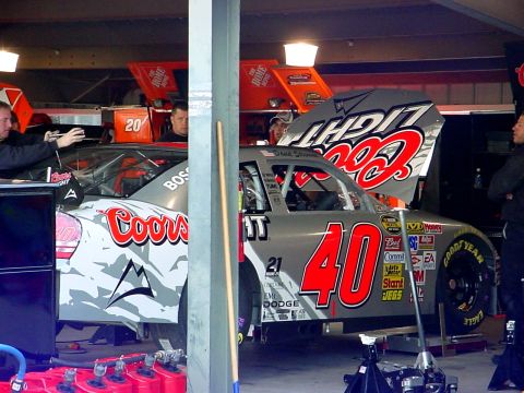 1993 Ford Mustang - Race cars with Coors Light sponsorship are being worked on in a garage.