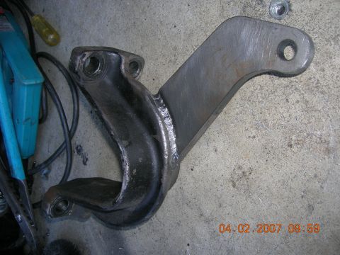 1996 Ford Bronco - A close-up view of a custom-fabricated suspension component, likely for an off-road vehicle, showing significant welding and mounting point…
