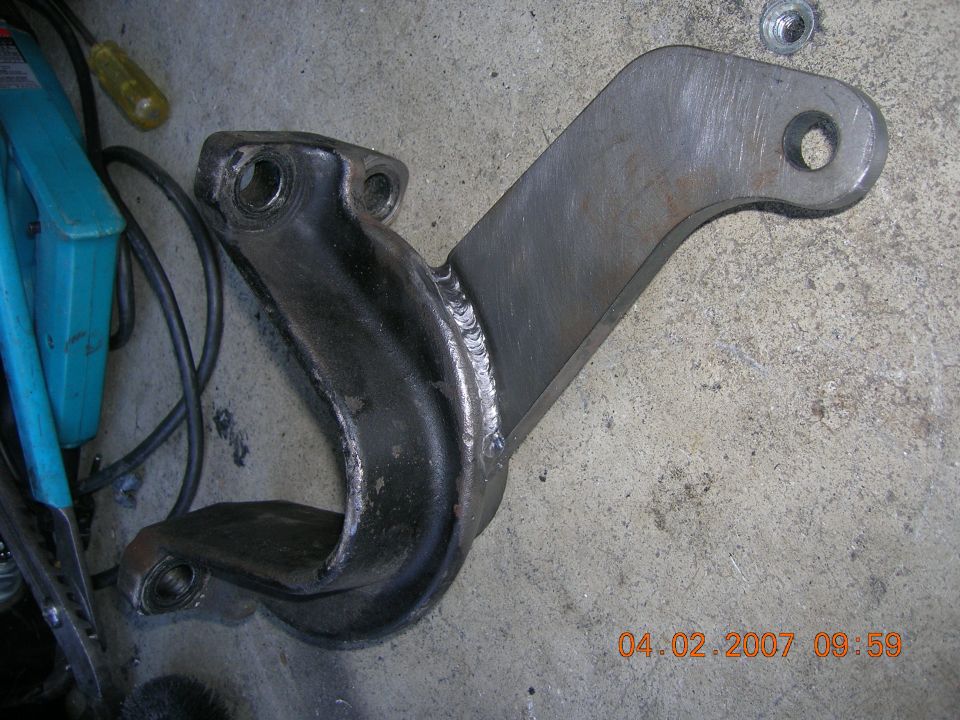 Custom suspension part with visible welds and bolt holes
