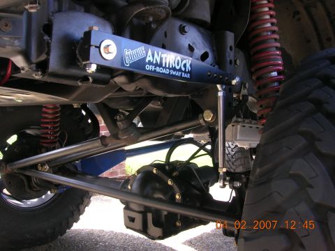 1996 Ford Bronco - Close-up view of an off-road sway bar installation, showing suspension and drivetrain components.