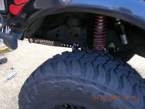 1996 Ford Bronco - Close-up view of off-road suspension modifications on a vehicle.