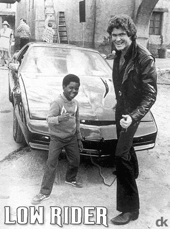 1991 Ford Bronco - David Hasselhoff and a boy pose with a black Pontiac Trans Am, possibly from Knight Rider.