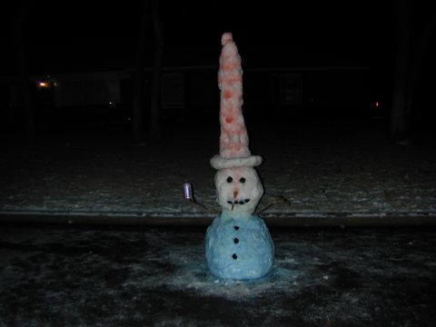 1996 Ford Bronco - A snowman stands in the dark, wearing a tall, striped hat and holding a can in its arm.