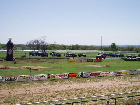 1978 Ford Bronco - A large gathering of off-road vehicles are seen at an outdoor event, with a giant inflatable Dr Pepper bottle in the background.