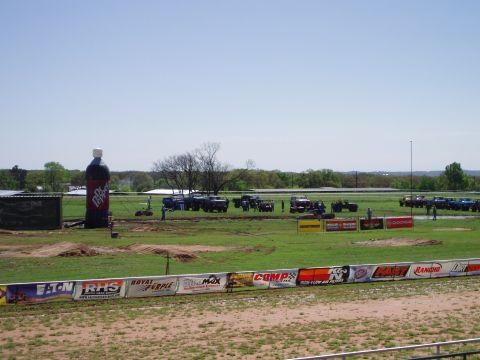 1978 Ford Bronco - An outdoor event features numerous trucks and SUVs on a field, with a large inflatable Dr. Pepper bottle visible.