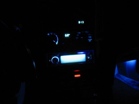1995 Ford Thunderbird - The car's interior lights up with a blue glow from the stereo and clock display.