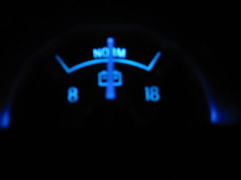 1995 Ford Thunderbird - A close-up of a car's illuminated gauge cluster at night.