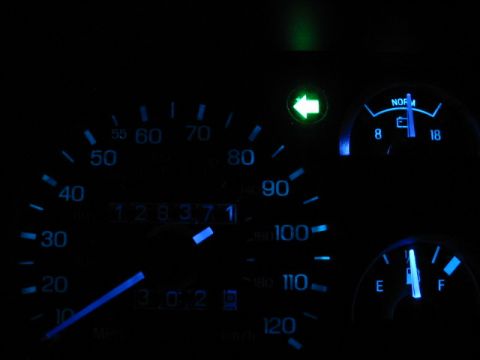 1995 Ford Thunderbird - The illuminated dashboard gauges display the odometer reading of 128,371 and other indicators.