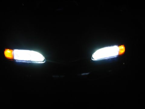 1995 Ford Thunderbird - Front view of a 1995 Ford Thunderbird's illuminated headlights and grille.