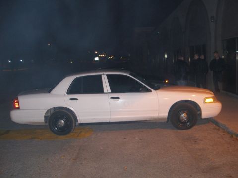 2003 Ford Crown Victoria - Side profile of a white 2003 Ford Crown Victoria parked outdoors at night.