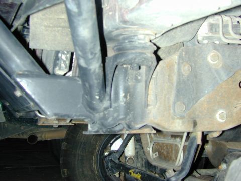 1996 Ford Bronco - A close-up view of the undercarriage of a vehicle, focusing on suspension and tire details.
