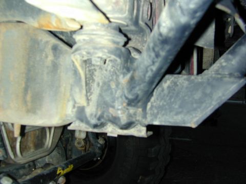 1996 Ford Bronco - Close-up view of vehicle undercarriage components, the Supermotors logo.