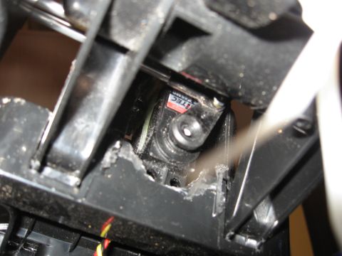 1990 Ford Bronco - A close-up view reveals a black servo motor with a visible 'ITEC' label, suggesting it is a component within a larger mechanism.