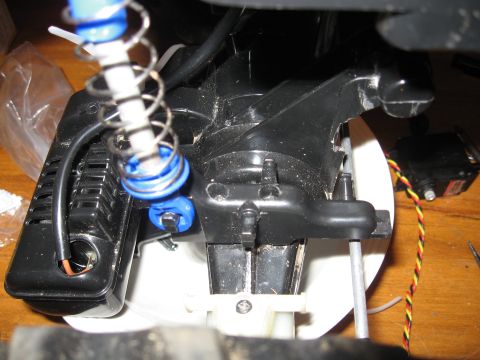 1990 Ford Bronco - Detail of mechanical parts, including springs and wiring, with a "SUPERMOTORS" logo visible at the bottom right.