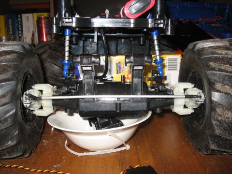 1990 Ford Bronco - Close-up view of the rear suspension and large tires on a remote-controlled monster truck.