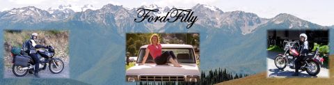 1979 Ford Bronco - A panoramic view two motorcycles and a truck with a person on its hood, framed by mountains.